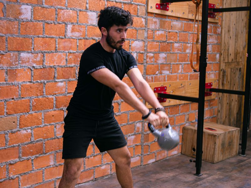 Man training with a kettlebell in a gym