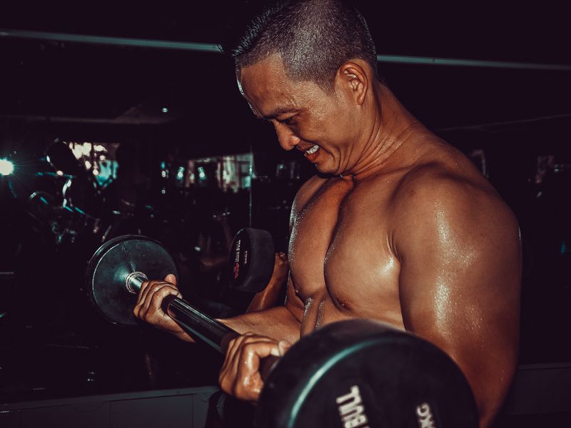 Man lifting a barbell in a gym